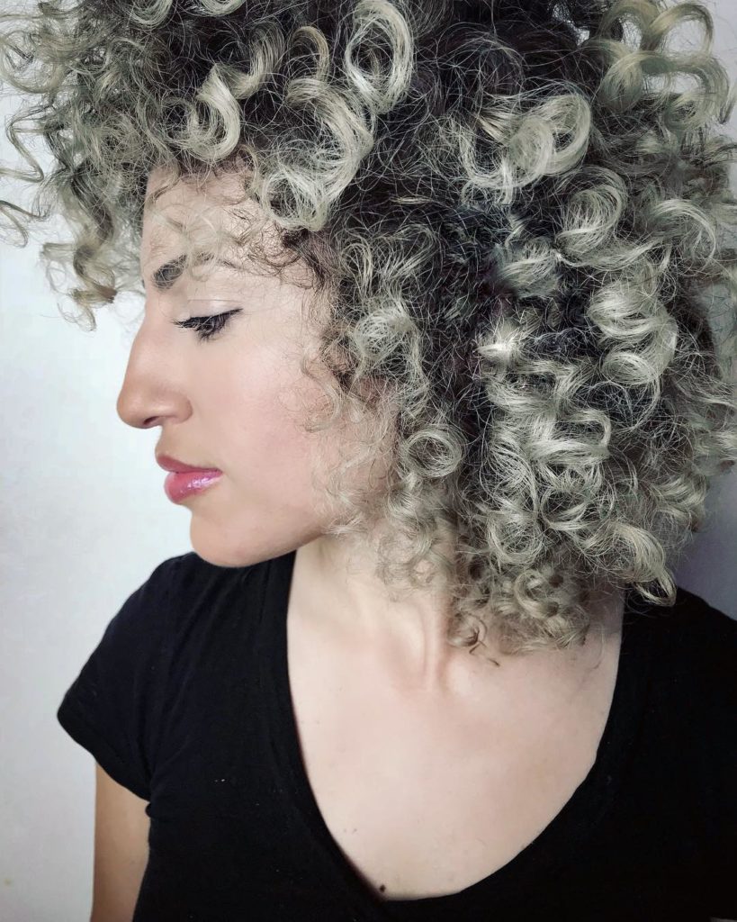 Capelli ricci ribelli liberi con sfumature chiare e scure
