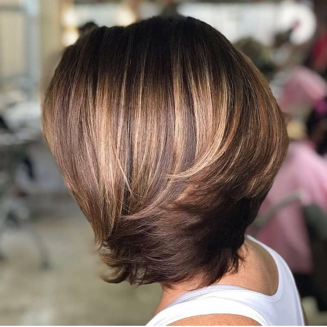 Capelli corti bombati con ciuffi che dalla nuca si muovono verso il viso e balayage biondo